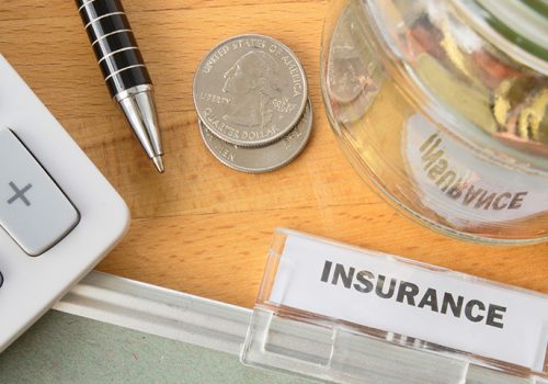 Insurance file Insurance file with calculator, pen, coins and glass jar